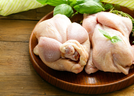 raw chicken meat with herbs and spicesの写真素材