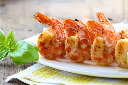 appetizer shrimp fried on skewers on a plateの写真素材