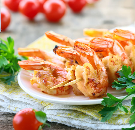 appetizer shrimp fried on skewers on a plateの写真素材