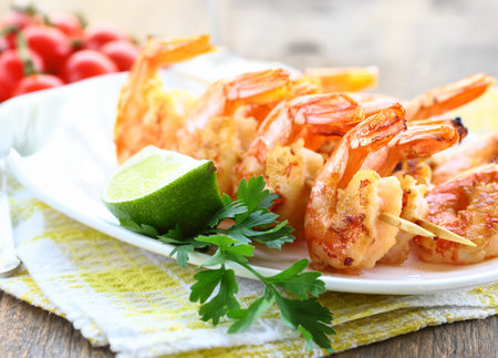 appetizer shrimp fried on skewers on a plateの写真素材