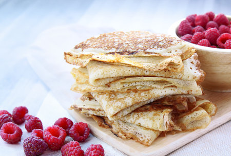 thin French crepe pancakes with fresh berries and honeyの写真素材