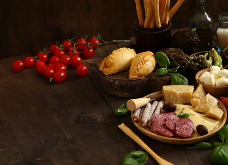 cheese and meat antipasto with olives and basilの写真素材