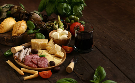cheese and meat antipasto with olives and basilの写真素材