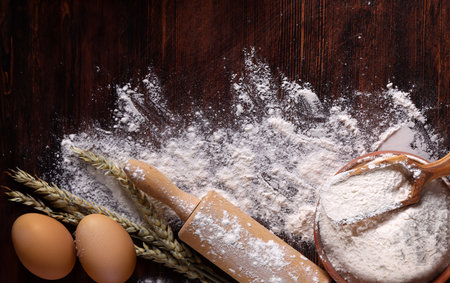 background for bakery flour and bread on wooden backgroundの写真素材