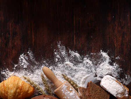background for bakery flour and bread on wooden backgroundの写真素材