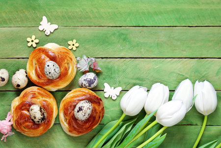 Easter buns and traditional eggs on wooden backgroundの写真素材