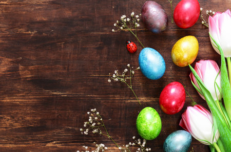 Easter composition with eggs and flowers on a wooden backgroundの写真素材