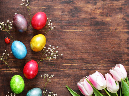 Easter composition with eggs and flowers on a wooden backgroundの写真素材