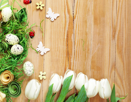 Easter composition with eggs and flowers on a wooden backgroundの写真素材