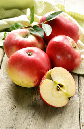 organic red apples on wooden tableの写真素材