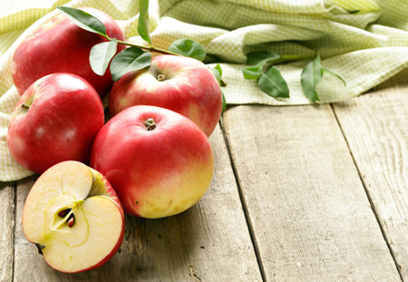 organic red apples on wooden tableの写真素材