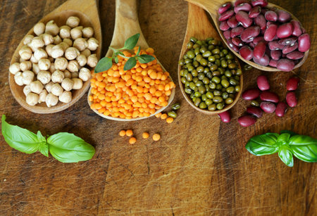assortment of cereals peas beans lentils in spoonsの写真素材