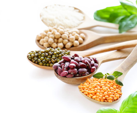 assortment of cereals peas beans lentils in spoonsの写真素材