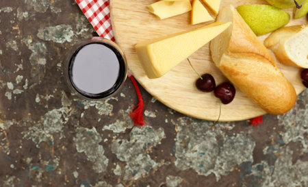 cheese board with baguette and grapesの写真素材