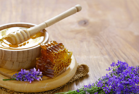 natural organic honey in honeycombs on a wooden tableの写真素材