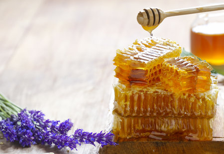 natural organic honey in honeycombs on a wooden tableの写真素材