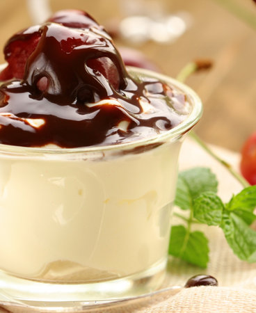 milk dessert with berries and chocolate sauce in a glassの写真素材