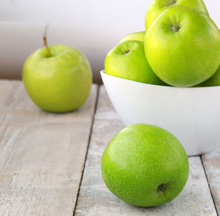 organic granny smith apples on wooden tableの写真素材