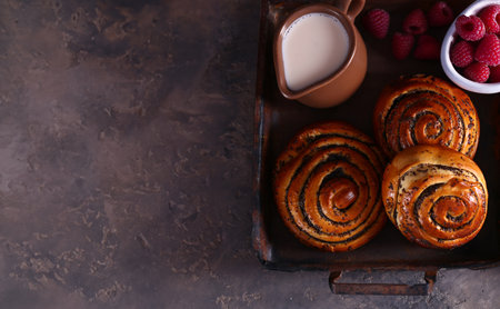 buns with poppy seeds for dessert treat on the tableの写真素材