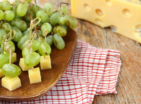 appetizer canapes grapes and cheese on a skewerの写真素材