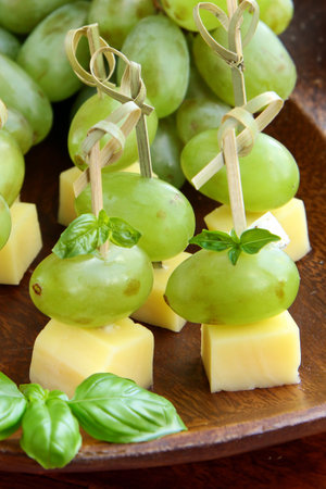 appetizer canapes grapes and cheese on a skewerの写真素材