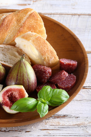 baguette with cheese and fresh fruit for snackの写真素材