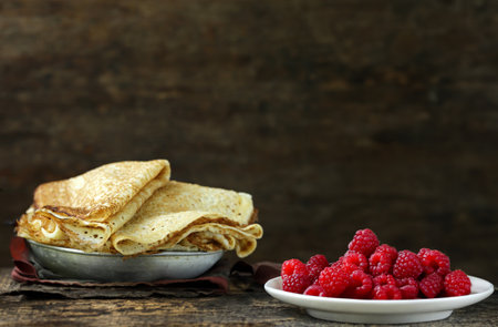 homemade thin pancakes with berries for breakfast and dessertの写真素材