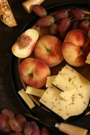 cheese board and fresh fruit grapes antipastiの写真素材