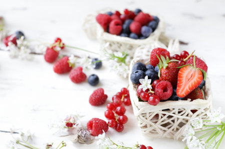 fresh berries raspberries strawberries currants on a wooden tableの写真素材