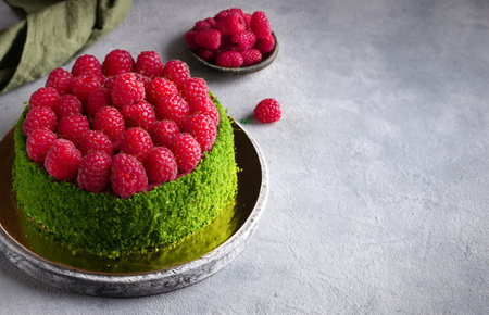 pistachio cake with fresh raspberries and buttercreamの写真素材
