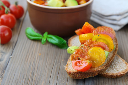 bruschetta with tomatoes and avocado on rye breadの写真素材