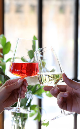 glasses of wine in hands holiday, meeting of friendsの写真素材