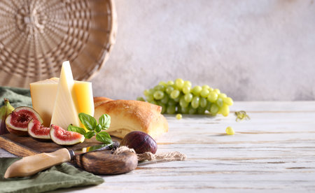 cheese board with baguette and grapesの写真素材