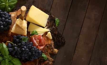 antipasti tapas with cheese and ham on wooden tableの写真素材