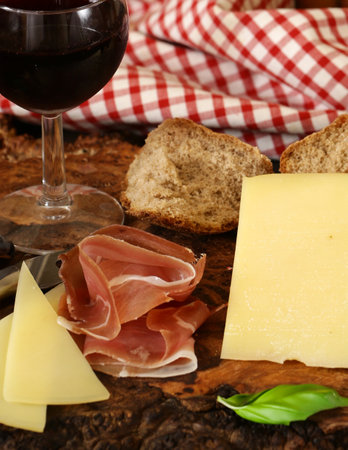 antipasti tapas with cheese and ham on wooden tableの写真素材