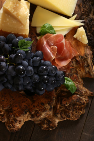 antipasti tapas with cheese and ham on wooden tableの写真素材