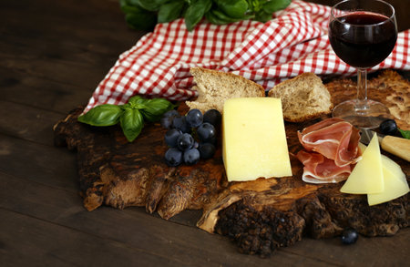 antipasti tapas with cheese and ham on wooden tableの写真素材