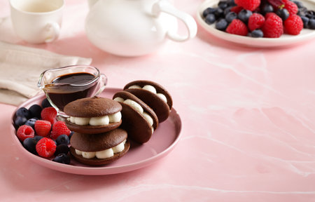 whoopie pie cookies with buttercream and berriesの写真素材
