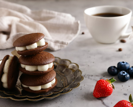 whoopie pie cookies with buttercream and berriesの写真素材