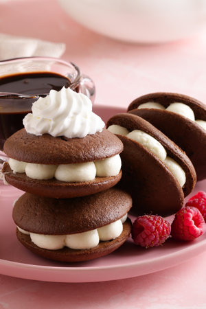 whoopie pie cookies with buttercream and berriesの写真素材