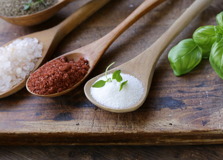 different varieties of salt in wooden spoonsの写真素材