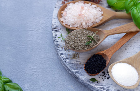 different varieties of salt in wooden spoonsの写真素材