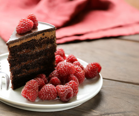 chocolate cake with whipped cream and berriesの写真素材