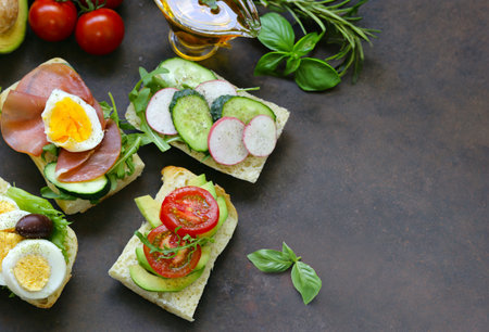 sandwiches with different fillings - vegetables, ham and eggの写真素材