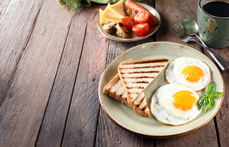 traditional breakfast with eggs salad and toastの写真素材
