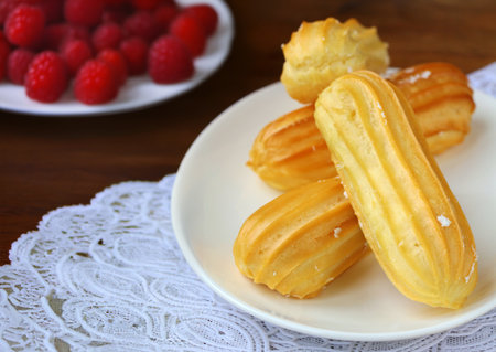 choux pastry eclairs with cream and berriesの写真素材