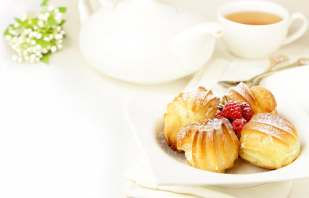 choux pastry eclairs with cream and berriesの写真素材