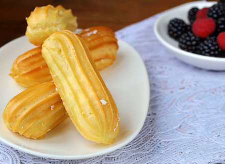 choux pastry eclairs with cream and berries