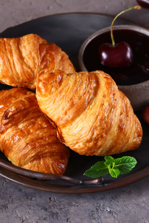 traditional croissants with jam for breakfastの写真素材