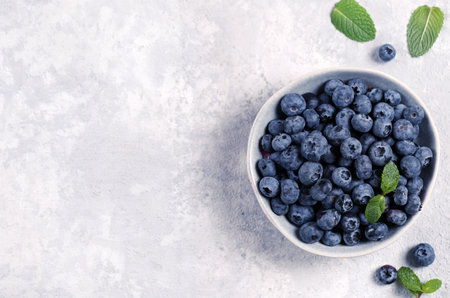 organic blueberries in bowl on gray backgroundの写真素材